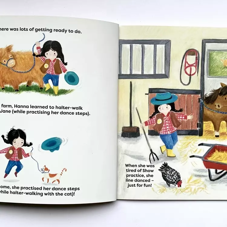 a picture of two pages of illustration from the highland cowgirl - showtime. the first page shows Hanna dancing with calamity Jane, the highland calf, beneath that there is an illustration of Hanna dancing with her cat on a lead. Hanna is illustrated wear